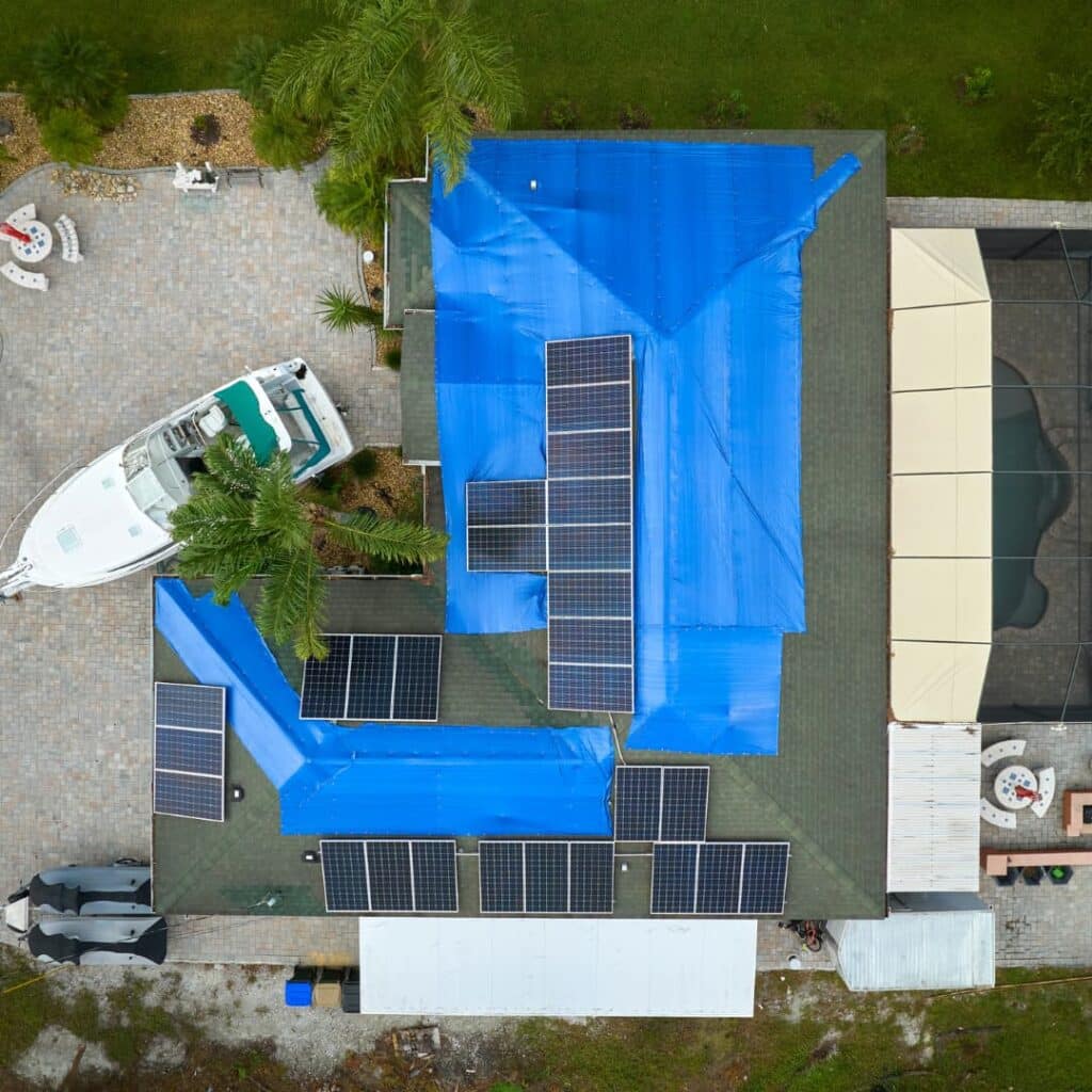 A roof that has been tarped. Aerial view. This is common during property damage emergencies.