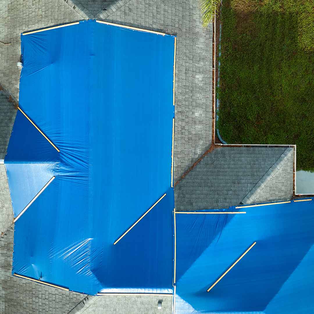 Blue tarp covering damaged roof