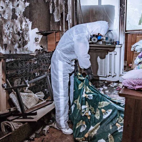 Worker removing debris after fire damage