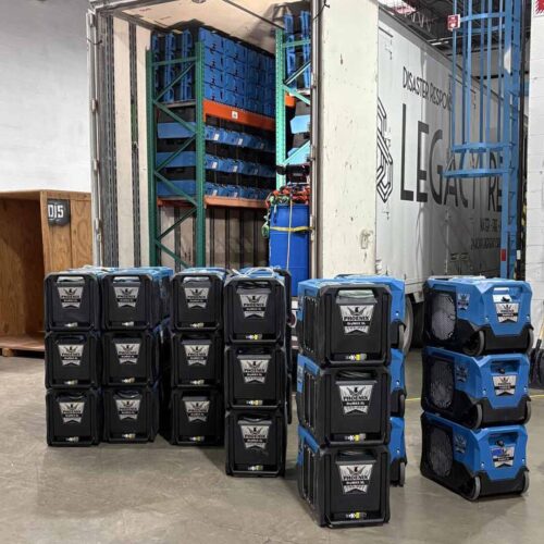 Commercial dehumidifiers and air movers lined up outdoors