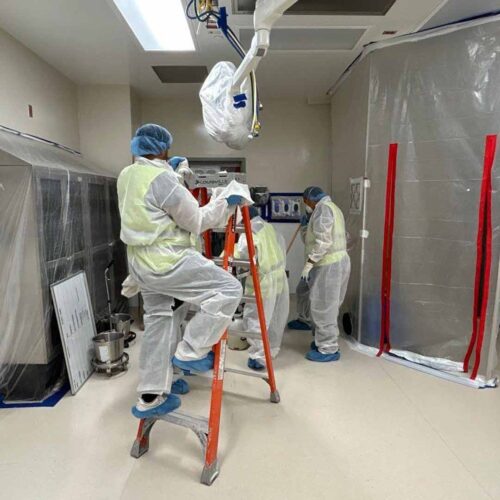 Crew performing restoration work in protective suits