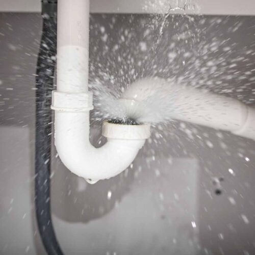 Frozen burst pipe spraying water