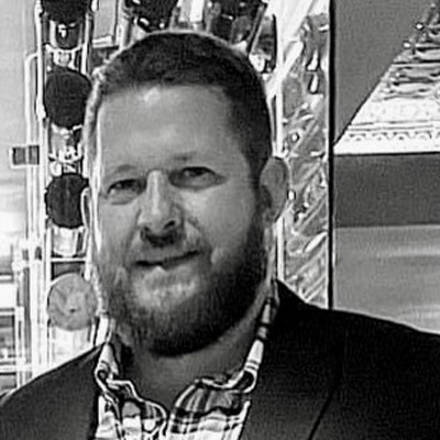 Black and white headshot of man with beard: Chris McCormick