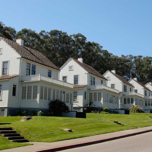 Apartment complex exterior with green lawn