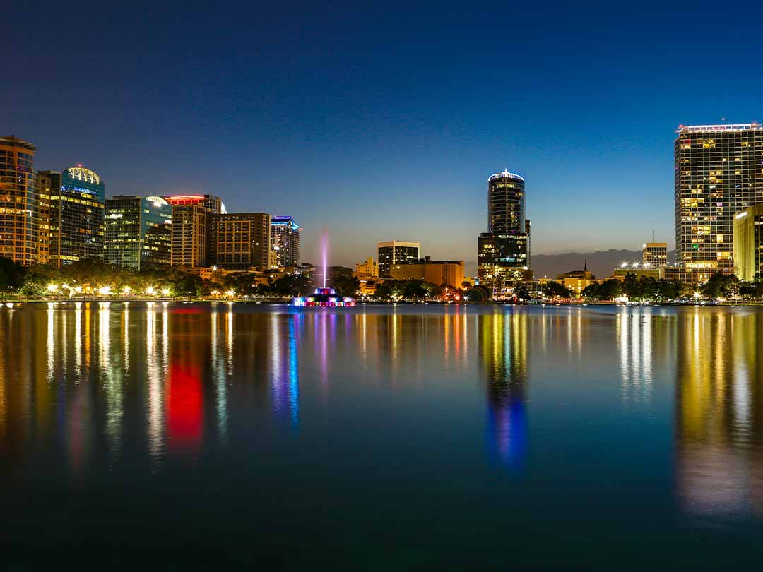 Downtown Orlando skyline reflected on water at night